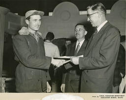 Plastering student receiving a diploma, ca. 1956