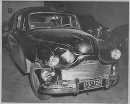 Dented car in auto shop, ca. 1950
