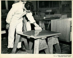 Student staining a tabletop, ca. 1960