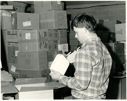 Student using a labeler in a warehouse