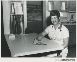 Nurse at a desk, ca. 1972