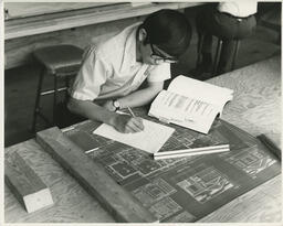 Student working on a drafting design, ca. 1972