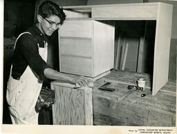 Student sanding a woodworking project, ca. 1956