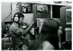 Electronics students with headphones at their stations