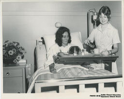 Nursing student serving meal to patient, ca. 1972