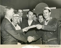Plastering student receiving a diploma, ca. 1955