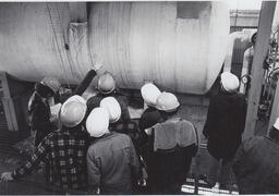 Students in hardhats on a tour of industrial building