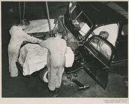 Three students working on car, ca. 1953
