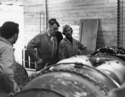 Instructors looking at turbine, ca. 1977