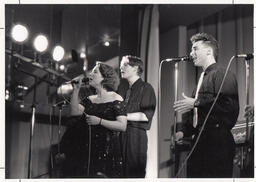 Students singing at microphones, ca. 1992