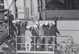 Students in hardhats on a tour of industrial building