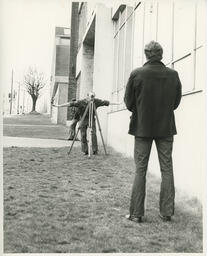 Two students using surveying tools, ca. 1972
