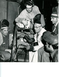 Instructor and students gathered around a machine, ca. 1972