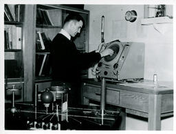 Student adjusting an electronic machine