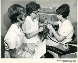 Dental students using tools