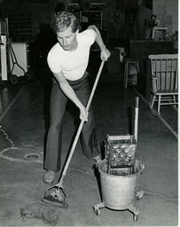 Student mopping floor