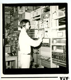 Student at wall of radio electronics