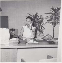 Student answering phone in office setting