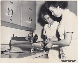 Students with dental tools on counter, ca. 1963