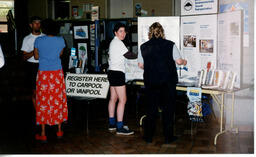 People in front of Go Green displays