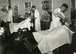 Barbering students shaving customers, ca. 1949