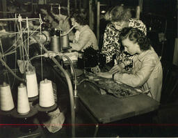 Instructor helping student at sewing machine