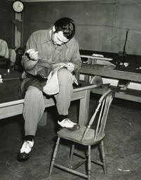 Tailoring student sewing a piece of fabric