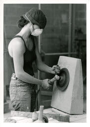 Student using a tool to smooth concrete