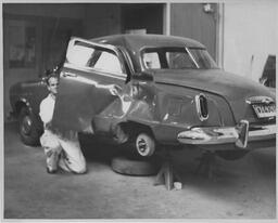 Student working on door of a car