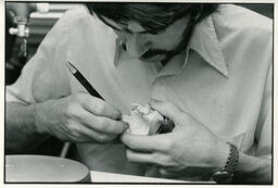 Dental student works on a plaster mouth model