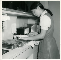 Student cleaning dental equipment
