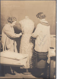 Miss E. Wastell and student pinning dress on a mannequin, Provincial Training program