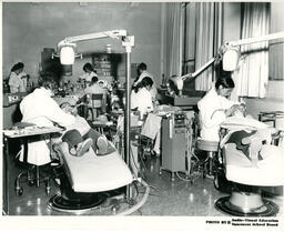 Student dental assistants examining children