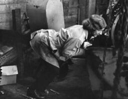 Person pushing turbine, ca. 1977