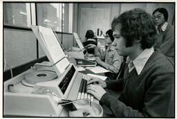 Person at a typing machine, ca. 1976