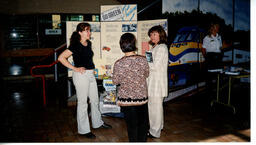 Three people at a Go Green display