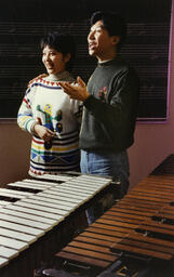 Two students singing in a music classroom
