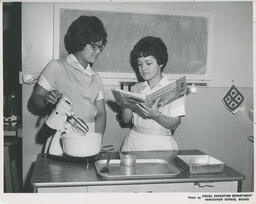 Two students in the Family Aide program in a kitchen classroom