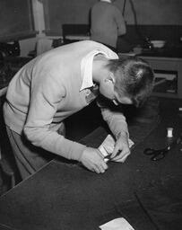 Tailoring student working with fabric