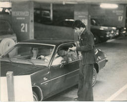 People in a car in a parkade