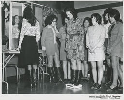 Group watching student on a scale