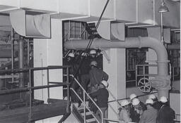 Students in hardhats on a tour of industrial building