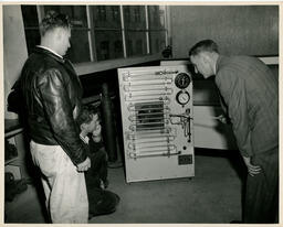 Engineering students looking at a machine, ca. 1949