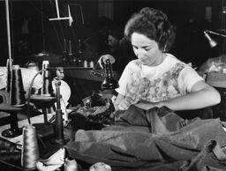 Student sewing fabric on a sewing machine