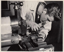 Student adding bolt to a machine
