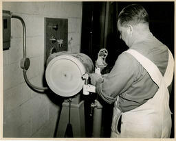 Student working at a sanding machine, ca. 1950