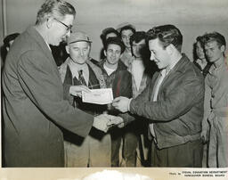 Plastering student receiving a diploma, ca. 1955