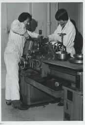 Two students working on machines