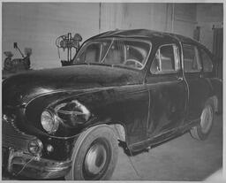 Black car with dented roof, ca. 1950