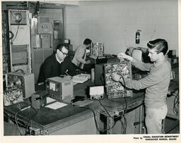 Students in a classroom working on electronics